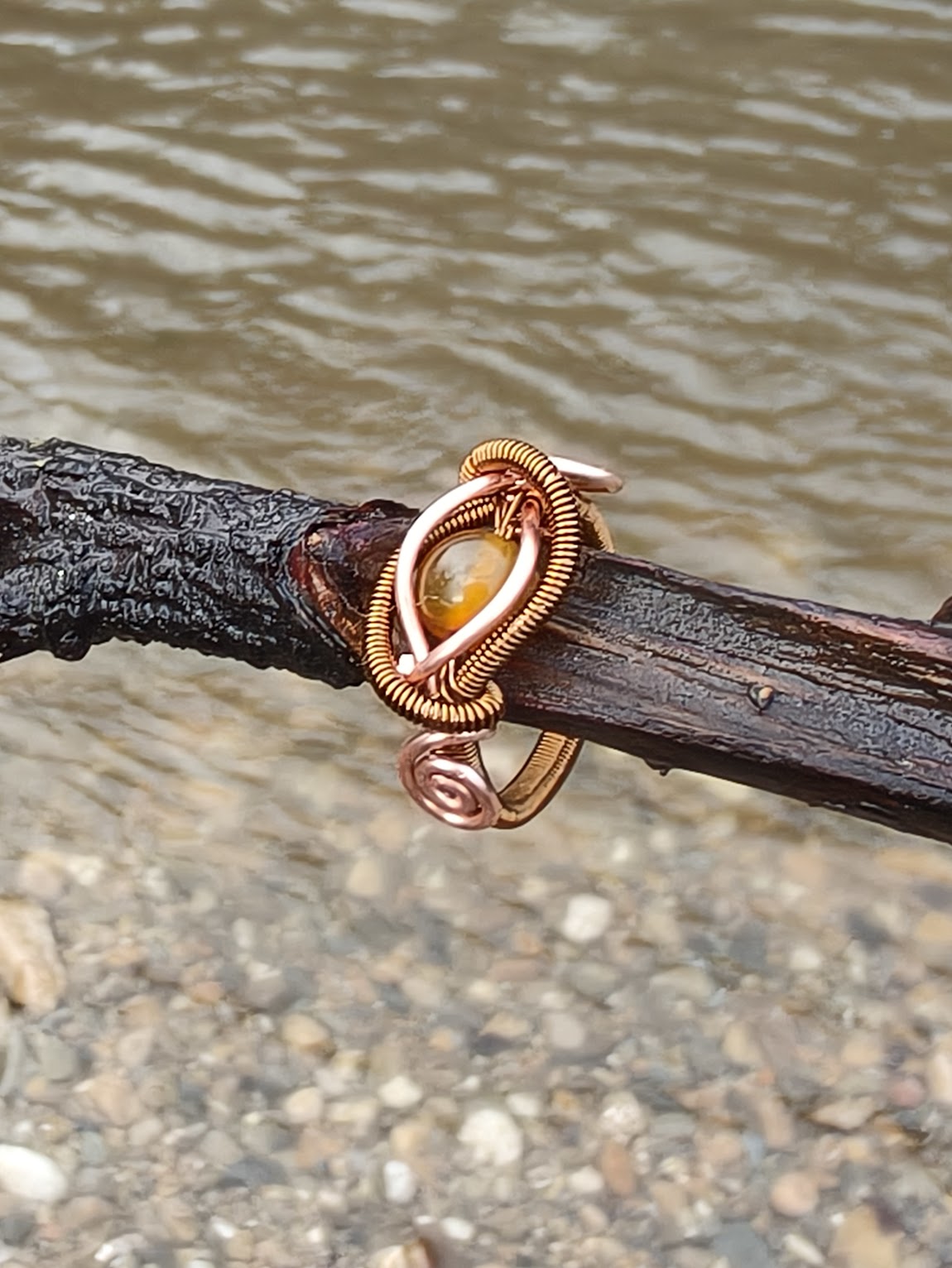 Anillo de cobre cálido con brillo ámbar