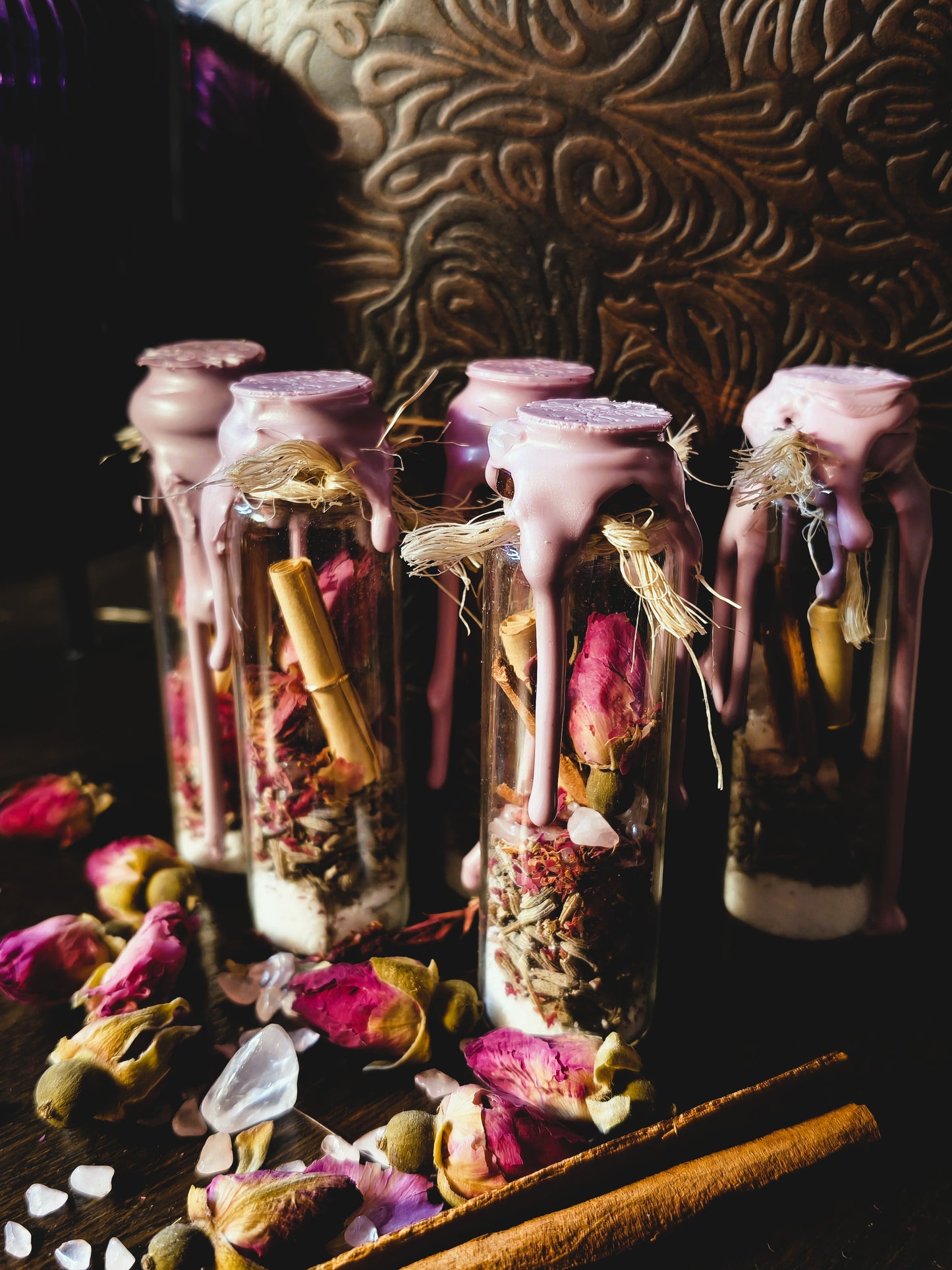 Handcrafted love spell jars sealed with pink wax, filled with dried rose petals, lavender, cinnamon sticks and pink quartz, displayed on a wooden surface with scattered rose petals and crystals, by Malika's Realm